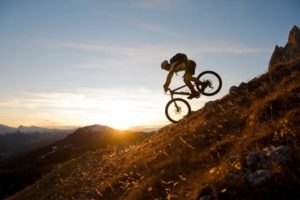 man biking downhill
